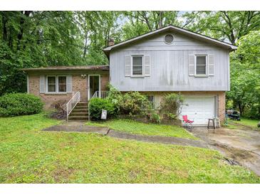 Split level home with a brick and gray wood facade and attached one car garage at 610 N Shaver St # 14, Salisbury, NC 28144