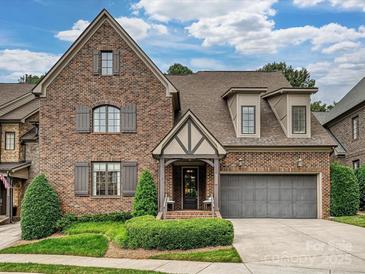 Beautiful brick home with a manicured lawn, covered entry and a two-car garage at 6128 Fletcher Cir, Charlotte, NC 28226