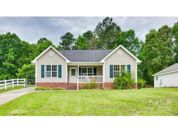 Charming single-story home with a well-maintained front yard and a cozy front porch at 2023 E Park Dr, Lancaster, SC 29720