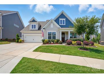 Charming single-Gathering home featuring a manicured lawn and beautiful landscaping with a two-car garage at 4527 Waylon Ave, Fort Mill, SC 29715
