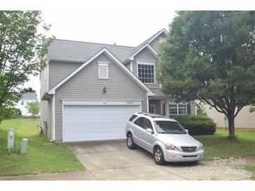Charming two-story home with a two-car garage and well-maintained lawn and landscaping at 6105 Follow The Trl, Indian Trail, NC 28079
