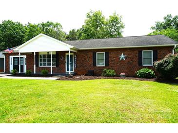 Charming brick home with well-maintained lawn, welcoming entrance, and patriotic decor at 1958 19Th Avenue Ne Dr # 8, Hickory, NC 28601