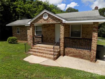 Charming brick home featuring a welcoming front porch and well-maintained landscaping at 209 Barber Rd, Gastonia, NC 28056