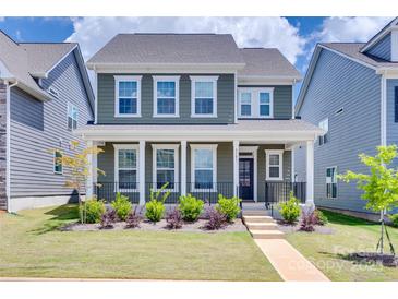 Charming two-story home with a covered front porch and manicured lawn at 3101 Virginia Trail Ct, Fort Mill, SC 29715