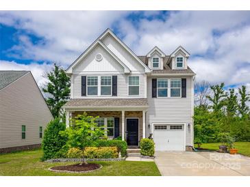 Charming two-story home with white siding, black shutters, covered porch, and a well-manicured lawn at 922 Bunker Trce, Rock Hill, SC 29730