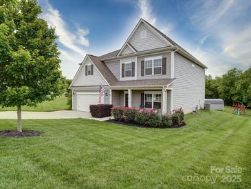 Charming two-story home with a manicured lawn, inviting front porch, and attached two-car garage at 114 Sierra Chase Dr, Statesville, NC 28677