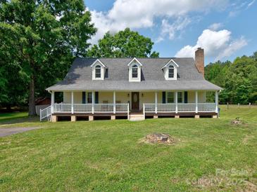 Charming ranch-style home with a spacious front porch and well-maintained lawn at 11850 Sugar Hill Rd, Davidson, NC 28036