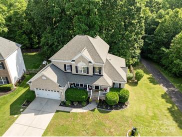 Aerial view of a two-story home with landscaped lawn and mature trees at 161 Dairy Farm Rd, Mooresville, NC 28115
