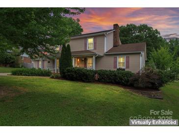 Charming two-story home with lush front lawn and inviting front porch at 1724 Windy Rush Ln, Gastonia, NC 28054