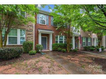 Charming brick townhome with well-maintained landscaping and a welcoming front entrance at 18460 W Catawba Ave, Cornelius, NC 28031