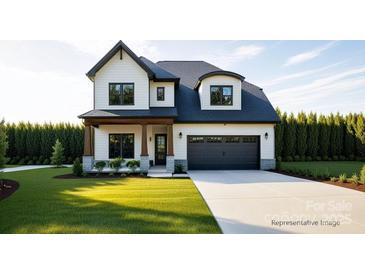 Charming two-story home boasts a manicured lawn, a dark gray garage door, and tasteful exterior accents at 20396 Queens St, Cornelius, NC 28031