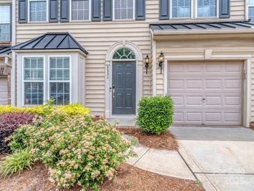 Inviting front door with an arched transom window, neutral siding and manicured landscaping at 2331 Whitford Ln, Charlotte, NC 28210