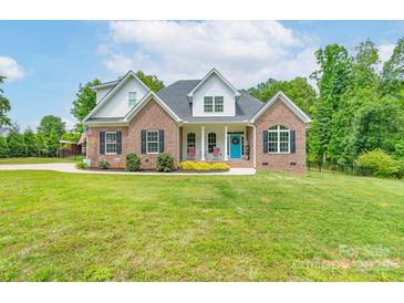 Charming brick two-story home with a vibrant blue door and manicured front yard landscaping at 3178 Newcastle Dr # 42, Rock Hill, SC 29732