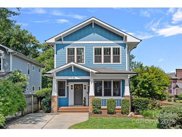 Charming blue two-story home featuring a welcoming front porch and well-maintained landscaping at 331 Solomon St, Charlotte, NC 28216