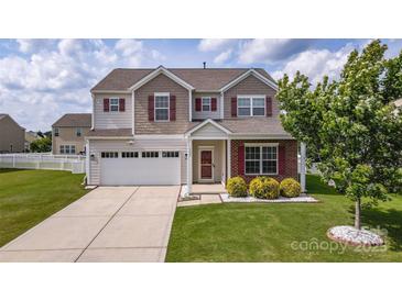 Charming two-story home featuring a well-manicured lawn and a two-car garage at 5003 Singletree Ln, Indian Trail, NC 28079