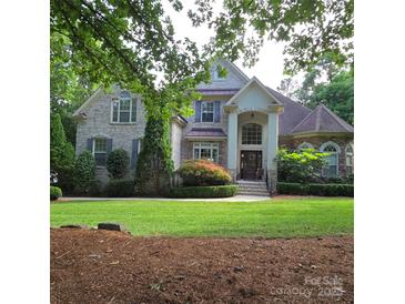 Charming two-story brick home with manicured lawn and lush landscaping at 6795 Montgomery Rd, Lake Wylie, SC 29710