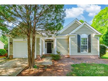 Charming home featuring attached garage, neutral siding, and manicured landscaping at 8339 Hornwood Ct, Charlotte, NC 28215