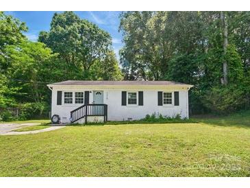 Charming one-story home features a well-maintained lawn, complemented by lush greenery and a welcoming front porch at 1215 Cardinal Dr # 9, Gastonia, NC 28052