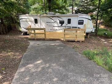 RV with a new wooden deck for relaxing and enjoying the outdoors at 131 Twin Bluff Trl, Mount Gilead, NC 27306
