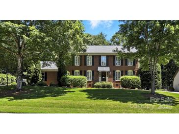 Traditional brick home featuring black shutters, manicured landscaping, and a lush front lawn at 147 35Th Ne Ave, Hickory, NC 28601