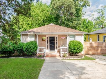 Charming single-story home featuring a cozy porch, well-maintained landscaping, and a welcoming entrance at 1817 Rush Wind Dr, Charlotte, NC 28206