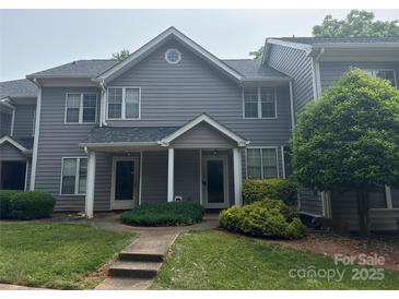 Charming gray townhouse with well-manicured lawn and a welcoming walkway at 2958 Iron Gate Ln, Charlotte, NC 28212