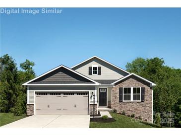 Charming two-story home featuring a stone facade, attached garage, and well-manicured lawn at 577 Nesbe St # 2222, Lancaster, SC 29720