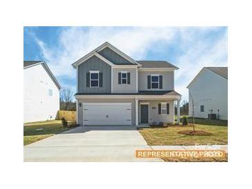 Charming two-story home showcasing traditional architecture and a well-manicured front lawn at 6336 Busch Ave, Midland, NC 28107