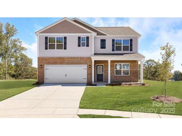 Charming two-story home with brick accents, attached two-car garage and well-manicured lawn at 7729 Woolsey Dr, Gastonia, NC 28056