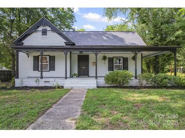 Charming home featuring a covered front porch, fresh landscaping, and light exterior at 118 Cabarrus W Ave, Concord, NC 28025