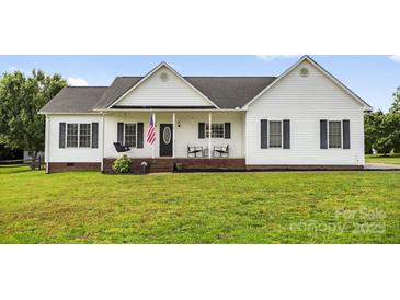Charming ranch-style home with white siding, dark shutters, and a welcoming front porch with rocking chairs at 170 Wagon Wheel Way # 4, Salisbury, NC 28147