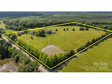 Expansive acreage featuring a serene pond and mature trees, ideal for country living at 18070 Old Beatty Ford Rd, Gold Hill, NC 28071