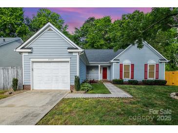Charming single-Gathering home featuring a one car garage, red shutters and door, and a well-manicured lawn at 3505 Frostmoor Pl, Charlotte, NC 28269