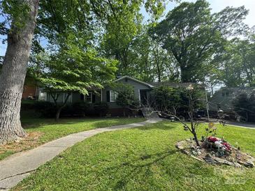 Charming home featuring a well-manicured lawn and inviting walkway at 616 E Oakwood Ave, Albemarle, NC 28001