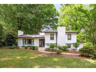 Charming white-brick home with well-manicured lawn and mature trees, offering great curb appeal at 7123 Linda Lake Dr, Charlotte, NC 28215
