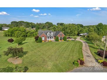 Expansive front yard, classic brick home, and private driveway highlight this property at 814 Settlers Dr, Cherryville, NC 28021
