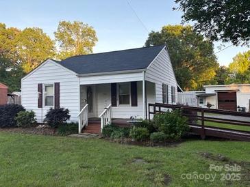 Charming single-story home featuring a landscaped front yard and accessible ramp at 1014 Skyway Dr, Kannapolis, NC 28083