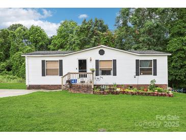 Charming single-story home with white siding, black shutters, and a lush green lawn at 103 Palace Pt, Kings Mountain, NC 28086