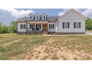 Charming two-story farmhouse style home featuring a welcoming front porch and dormer windows at 1134 Fincher Rd, Fort Lawn, SC 29714