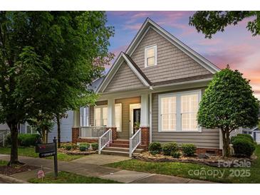 Charming home featuring shingle siding, manicured landscaping, and inviting front porch at 15913 Trenton Place Rd, Huntersville, NC 28078