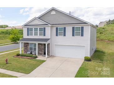 Charming two-story home featuring stone accents, blue shutters, and a well-manicured lawn at 1600 Gaston Mountain Dr, Dallas, NC 28034