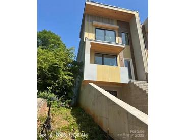 Modern multi-story home featuring large windows, and a stylish design at 312 Wesley Heights Way # A, Charlotte, NC 28208
