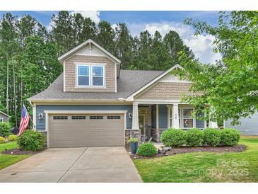 Charming two-story home with a well-manicured lawn and a two-car garage, exuding curb appeal at 528 Sandbar Pt, Clover, SC 29710