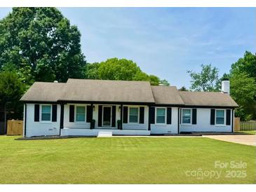 Charming ranch-style home with a well-manicured lawn and a welcoming front entrance at 554 Isle Of Pines Rd, Mooresville, NC 28117