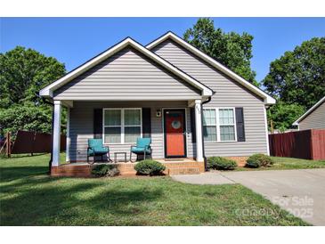 Charming single-Gathering home featuring a welcoming front porch and well-maintained lawn at 650 Harry St, China Grove, NC 28023