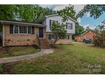 Charming two-story home featuring brick and siding with a well-manicured lawn and inviting front entrance at 6921 Idlewild Rd, Charlotte, NC 28212