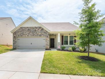 Charming one-story home featuring a stone facade, attached garage, and a well-manicured lawn and landscaping at 805 Old Little Rock Rd, Charlotte, NC 28214