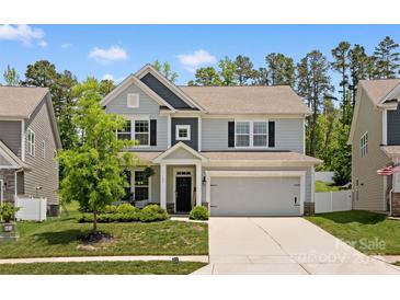 Charming two-story home with attached two-car garage and well-maintained lawn at 107 Hornbeam Ln, Mooresville, NC 28117