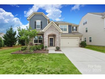 Two-story home with stone archway, two-car garage, and manicured front lawn at 1914 Loggerhead Dr, Lancaster, SC 29720
