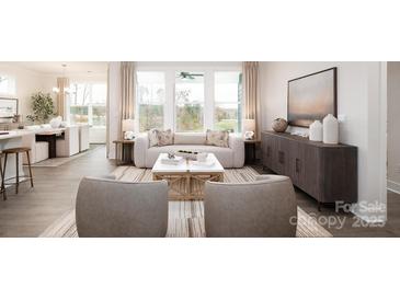 Bright living room featuring large windows, stylish furniture, and modern decor creating an inviting atmosphere at 2066 Skyhawk Dr, York, SC 29745
